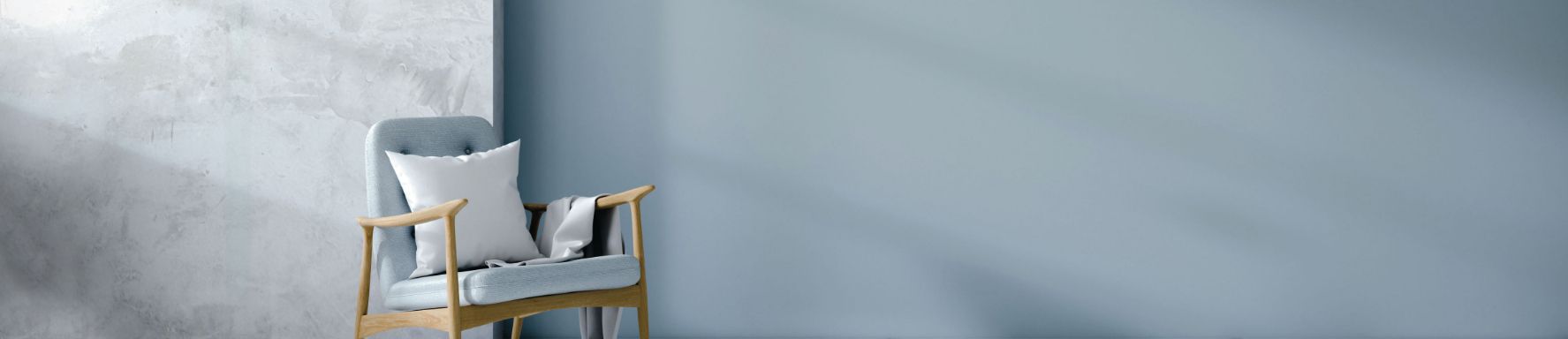 Pareti decorative Oikos in toni chiari e azzurri con poltrona contemporanea